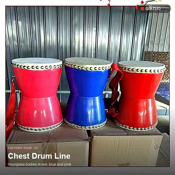 Three chest drums in red and blue lined up on a pallet at QiaTuo