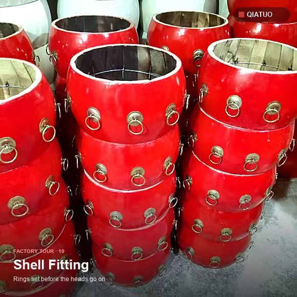 Red drum shells fitted with chrome rings and lugs awaiting heads at QiaTuo workshop